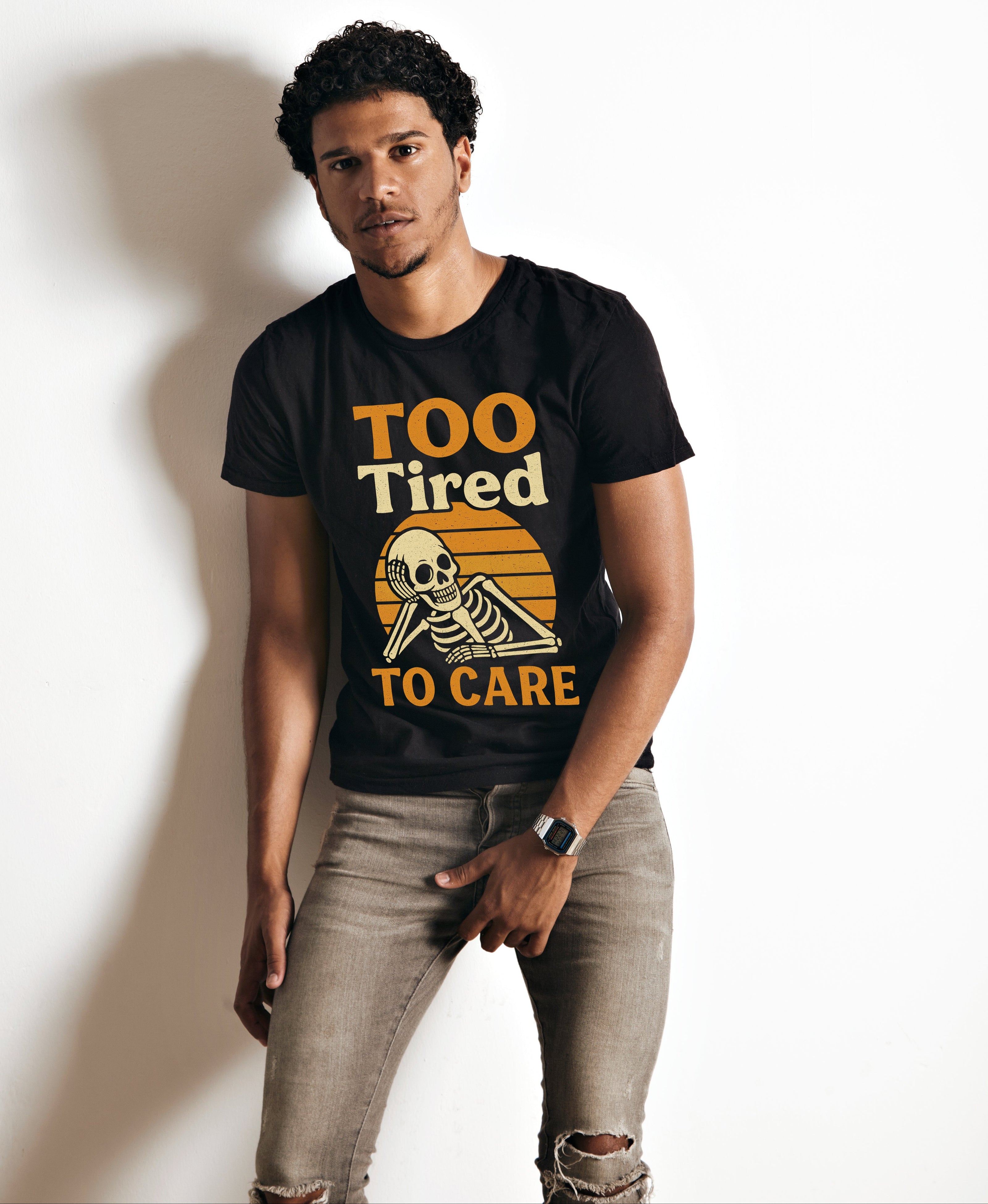 Man wearing a black t-shirt with a skeleton design and text on a white background